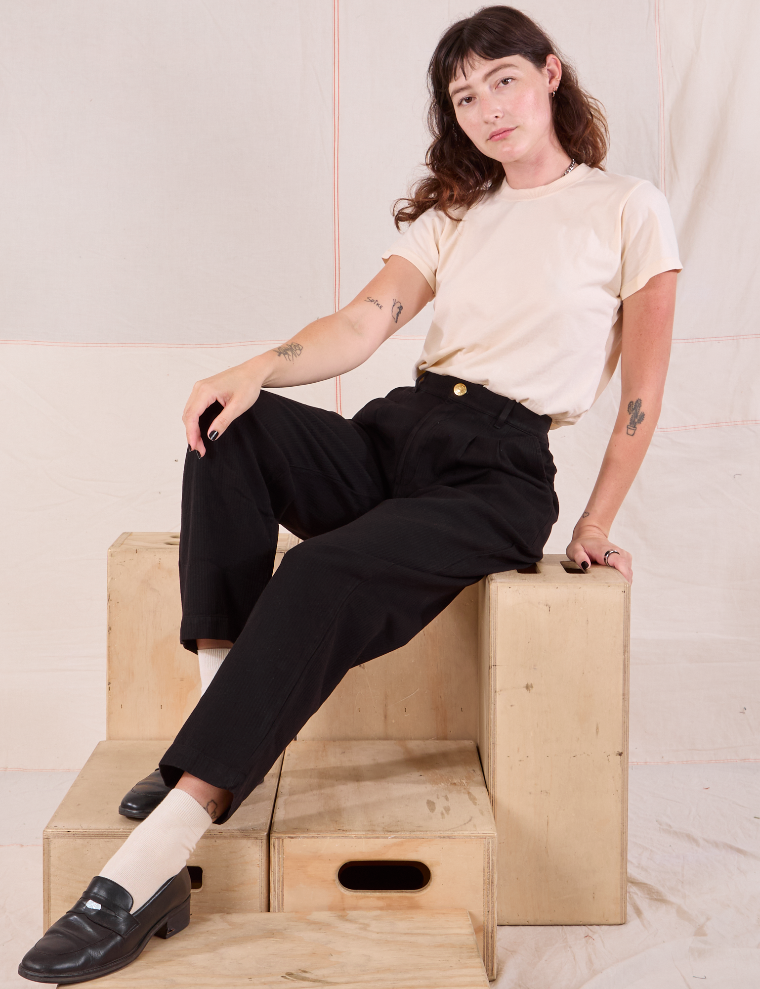 Alex is wearing Heritage Trousers in Basic Black and Organic Vintage Tee in vintage tee off-white