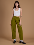 Alex is 5’8” and wearing XXS Heritage Trousers in Olive Green paired with a vintage tee white Cropped Tank