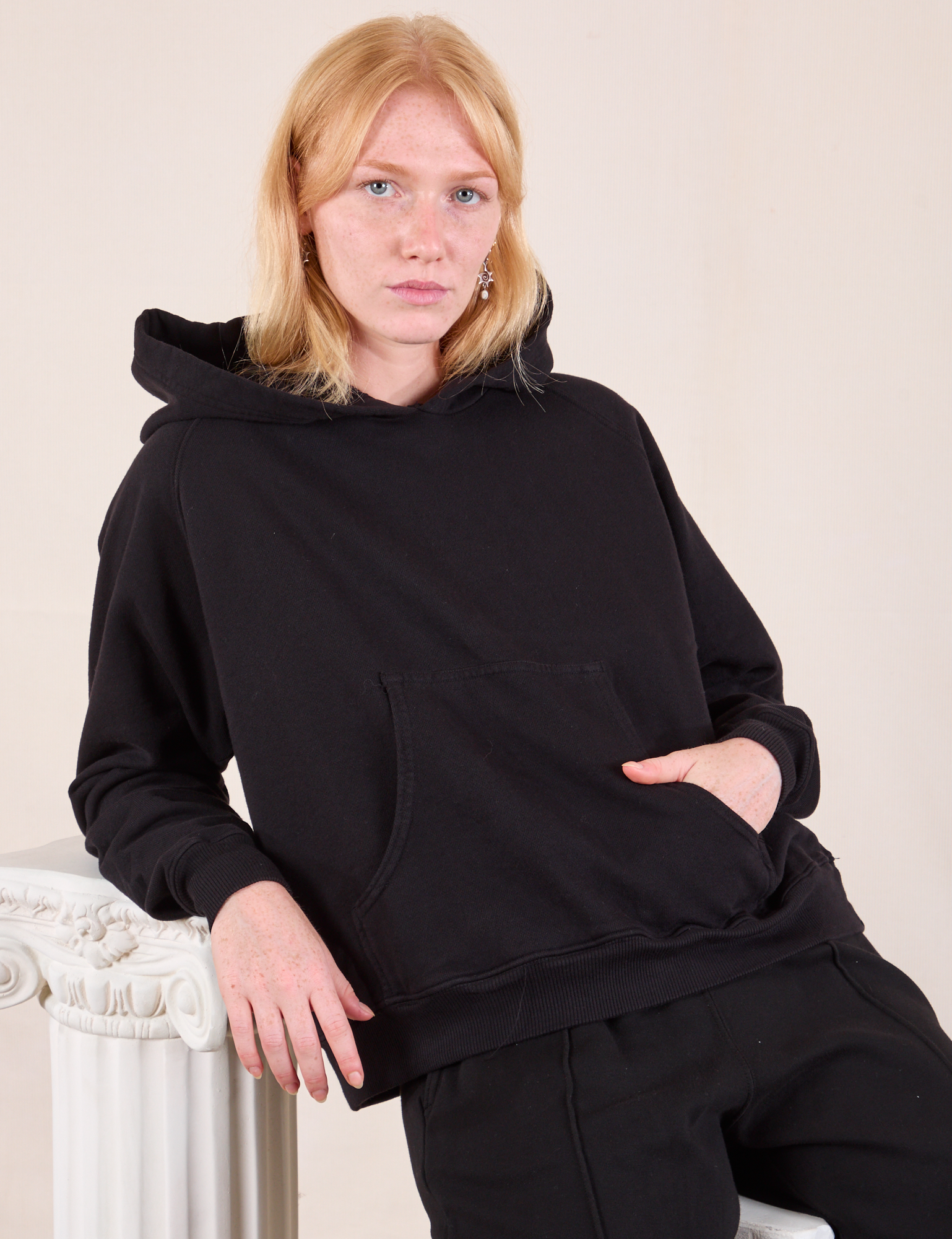 Margaret is 5'11" and wearing XS Oversized Hoodie in Basic Black