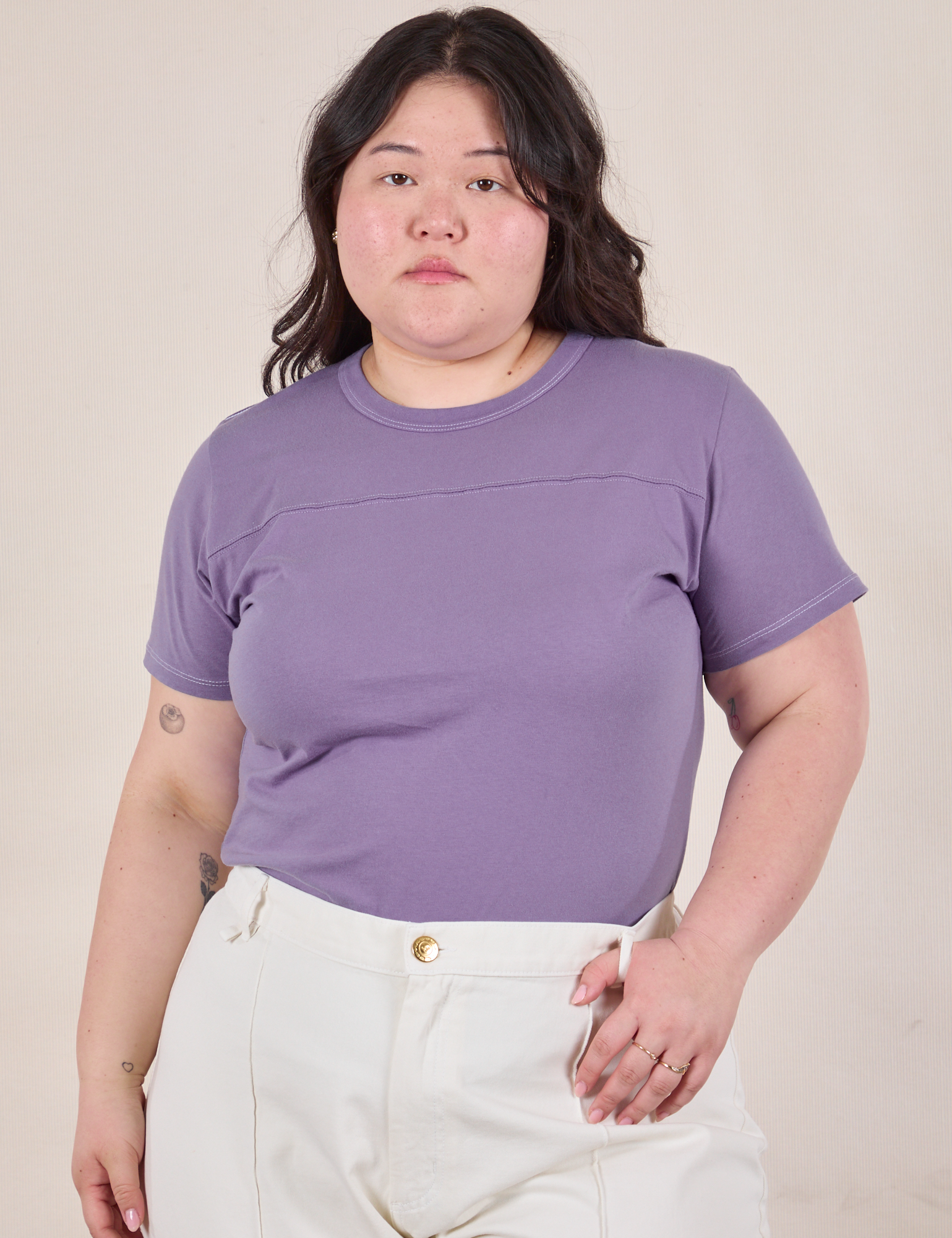 Ashley is 5'7" and wearing L Jr. Varsity Tee in Faded Grape