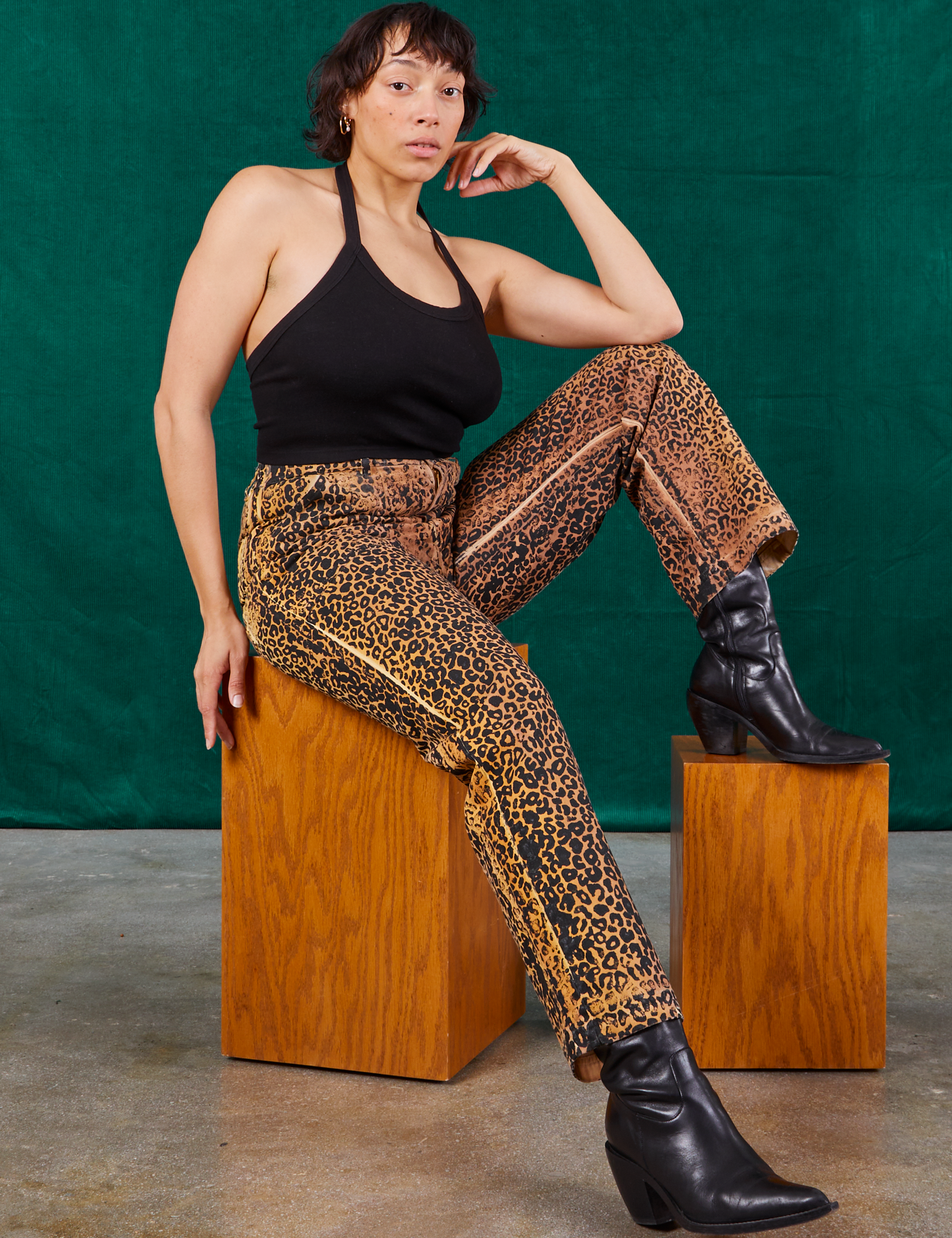 Tiara is wearing Leopard Work Pants paired with black Halter Top