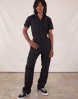 Jerrod is 6'3" and wearing M Long Jumpsuit in Basic Black