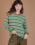 Alex is 5’8” and wearing P Long Sleeve Striped Burly Tee in Green