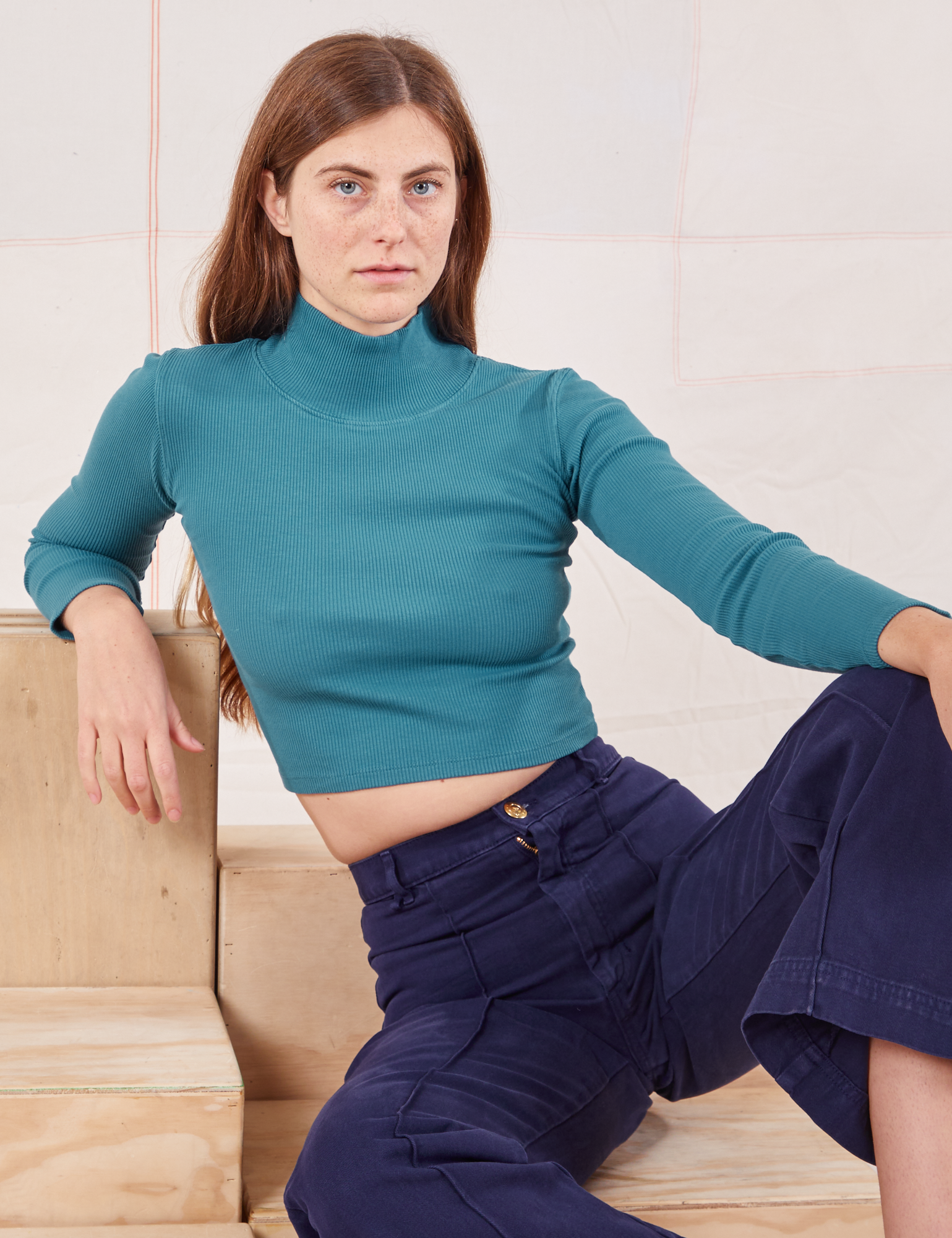 Scarlett is 5&#39;9&quot; and wearing P Essential Turtleneck in Marine Blue paired with navy Western Pants