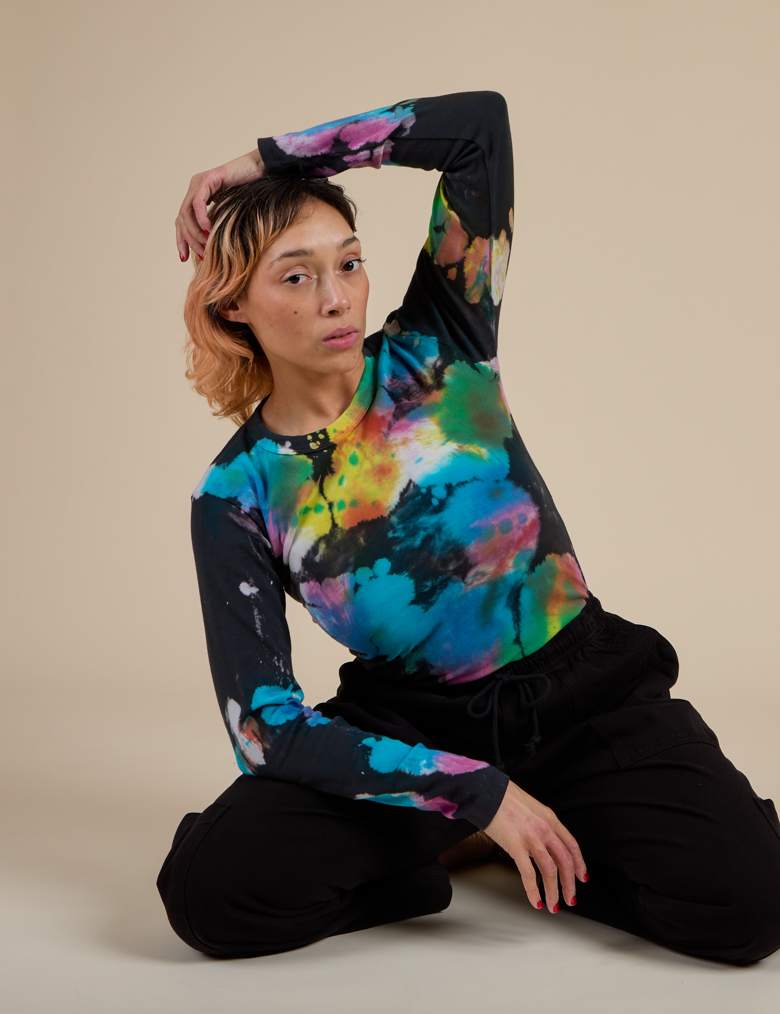 Tiara is wearing Long Sleeve Baby Tee in Rainbow Magic Waters