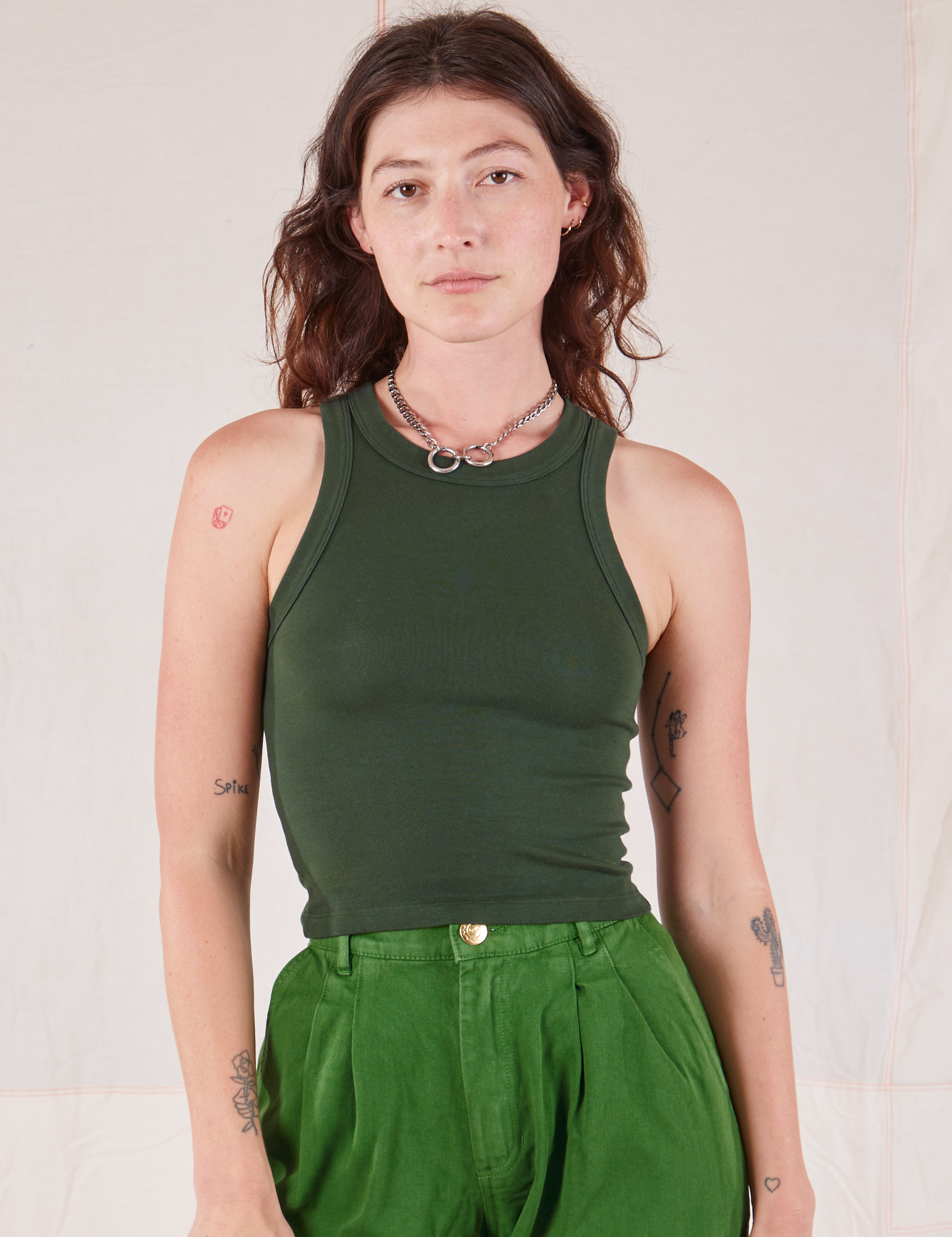 Alex is 5’8” and wearing P Racerback Tank in Swamp Green