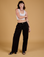 Alex is 5'8" and wearing XXS Baggy Mid-Rise Trousers in Basic Black paired with a vintage tee white Cropped Tank