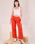 Alex is 5'8" and wearing XXS Mid-Rise Pleated Trousers in Chili Red paired with a Cropped Tank in Vintage Tee Off-White