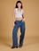 Alex is 5'8" and wearing XXS Baggy Mid-Rise Trousers in French Blue paired with a vintage tee white Cropped Tank