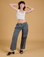 Alex is 5'8" and wearing XXS Baggy Mid-Rise Trousers in Slate Grey paired with a vintage tee white Cropped Tank