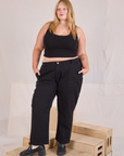 Juliet is 5'7" and wearing 2XL Mid-Rise Work Pants in Basic Black paired with black Cropped Tank