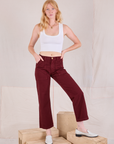 Margaret is 5'11" and wearing XS Mid-Rise Work Pants in Red Wine paired with a Cropped Tank in vintage tee off-white