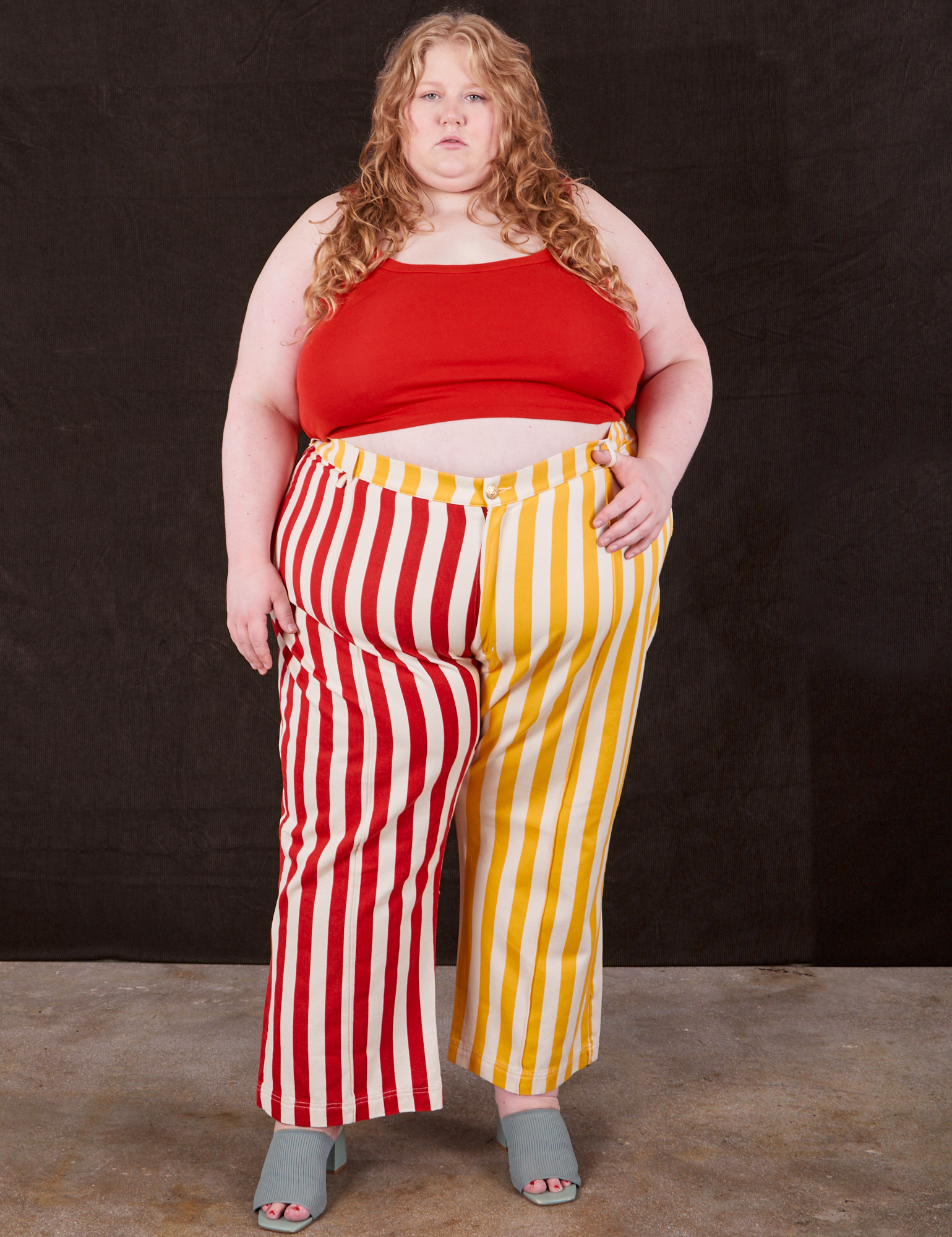 Catie is 5&#39;10&quot; and wearing 5XL Western Pants in Ketchup/Mustard Stripes paired with mustang red Cami