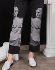 Close up of airbrushed Venus on black Work Pants worn by Alex