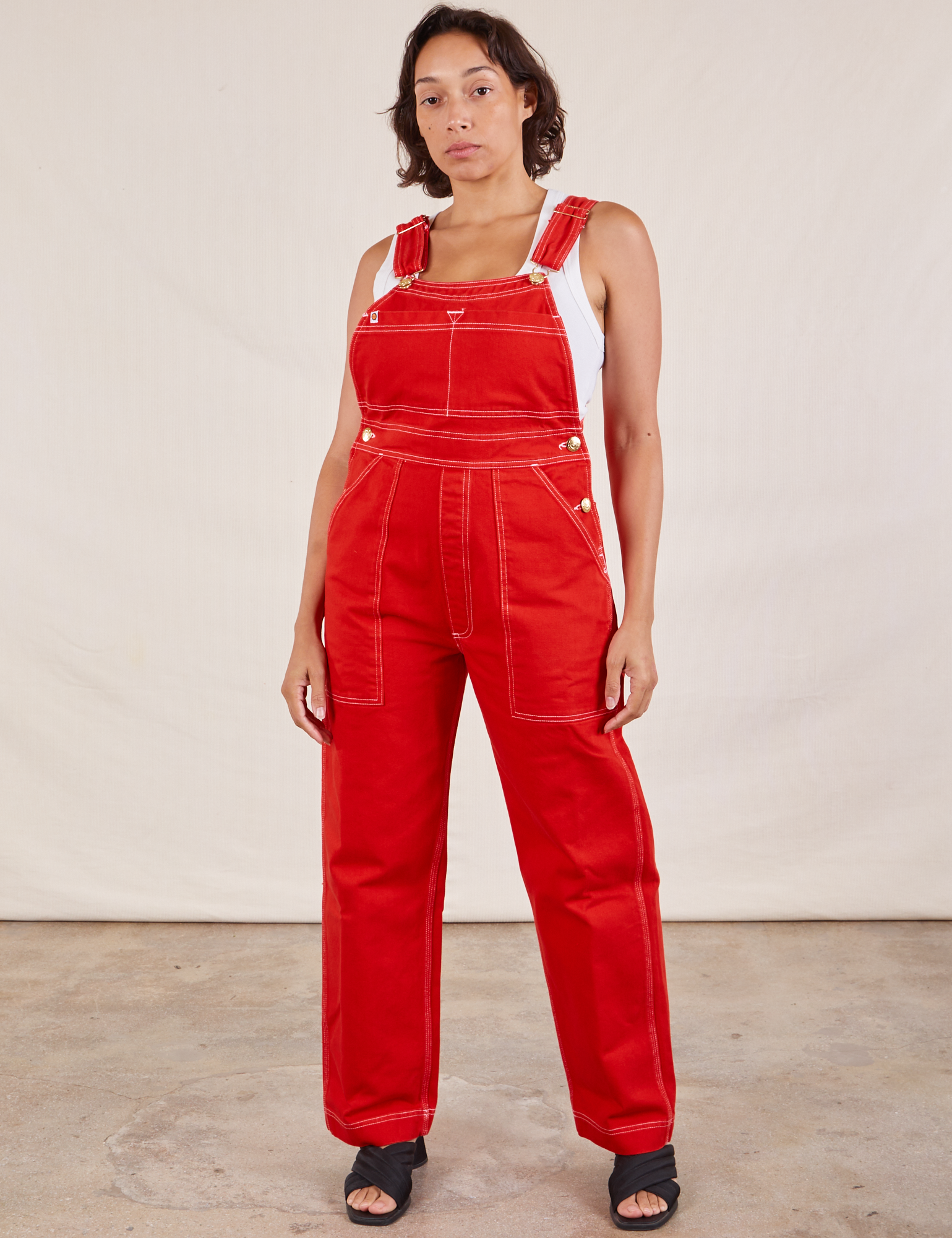 Tiara is 5'4" and wearing XS Original Overalls in Mustang Red