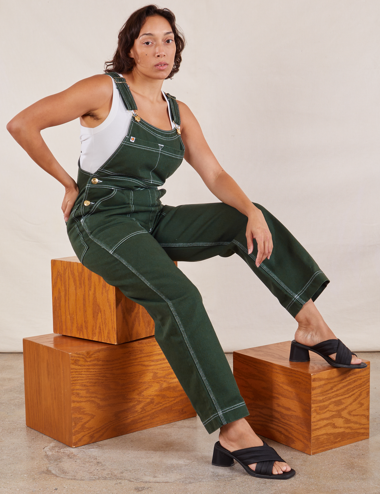 Tiara is 5'4" and wearing XS Original Overalls in Swamp Green