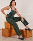 Tiara is 5'4" and wearing XS Original Overalls in Swamp Green