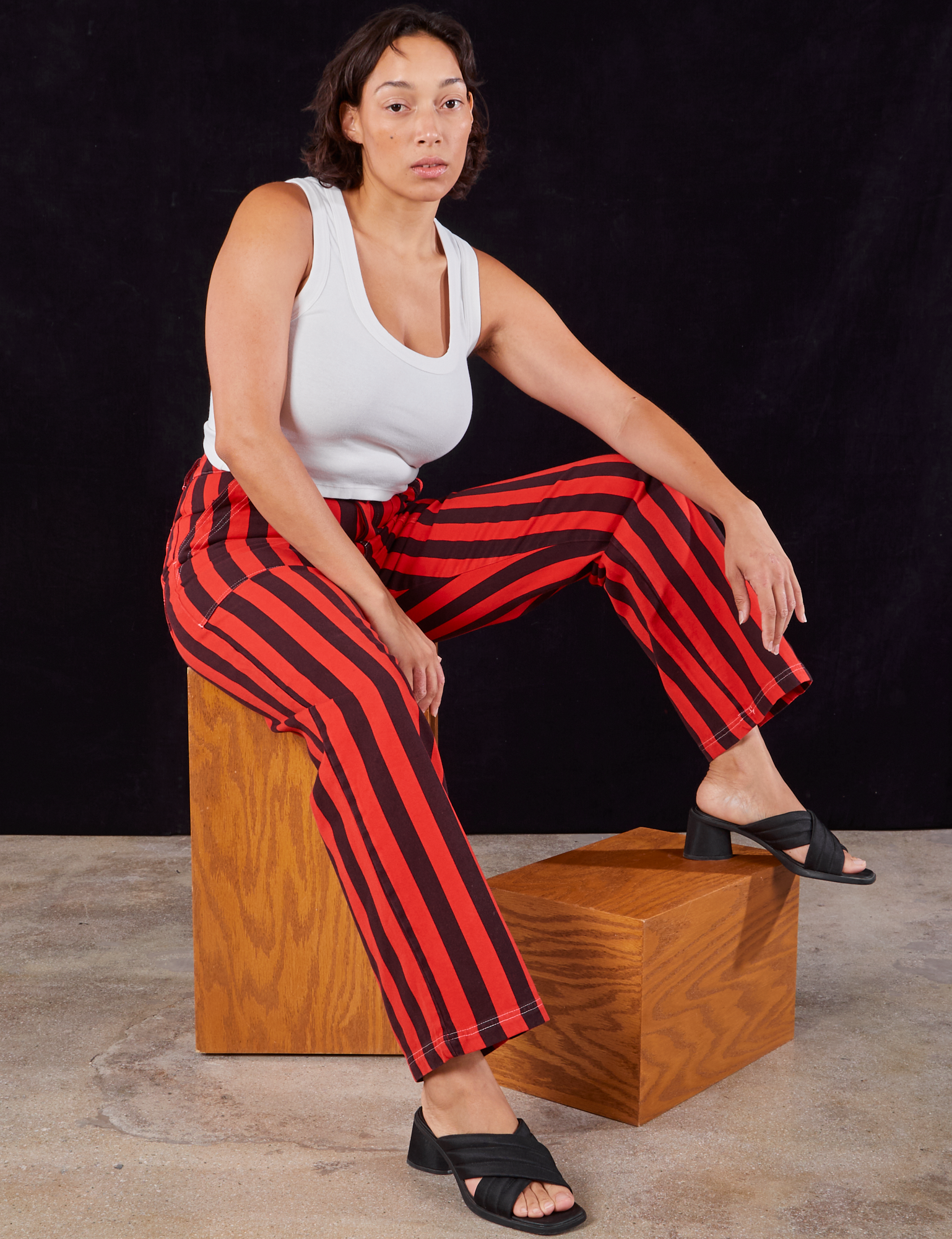 Tiara is wearing Black Stripe Work Pants in Mustang Red