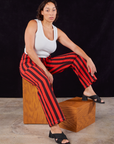 Tiara is wearing Black Stripe Work Pants in Mustang Red