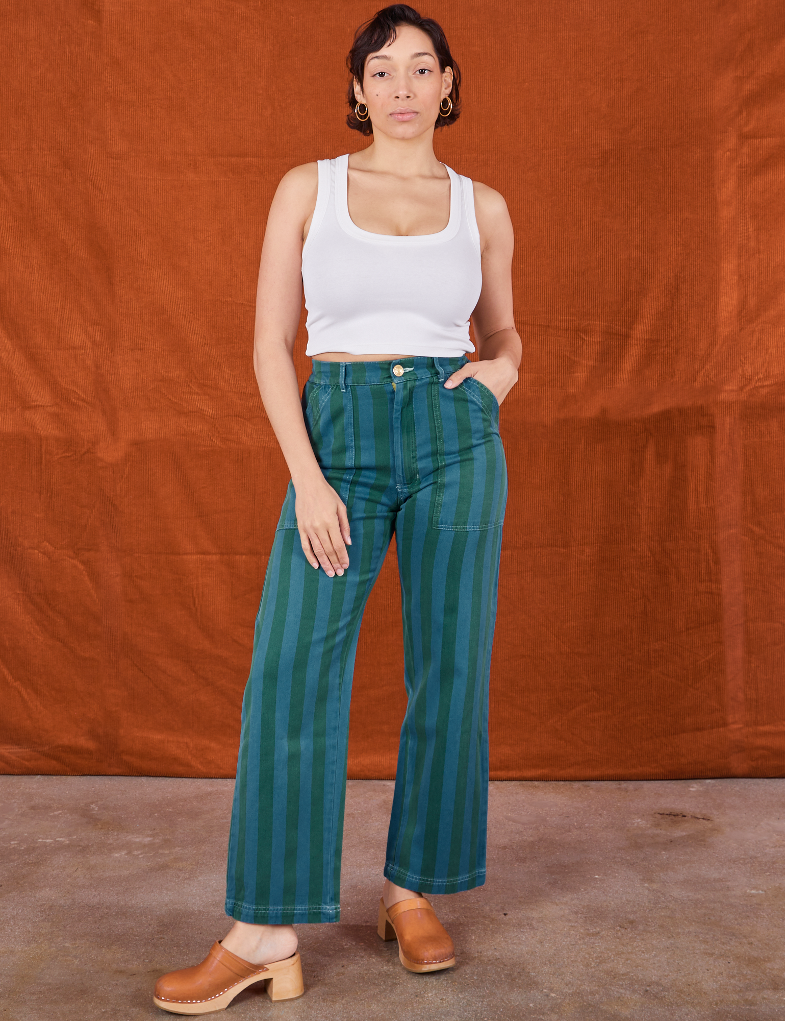 Tiara is 5&#39;4&quot; and wearing size S Overdye Stripe Work Pants in Blue/Green paired with vintage off-white Cropped Tank Top