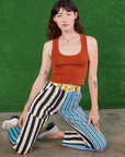 Alex is wearing Mismatched Stripe Work Pants and burnt terracotta Cropped Tank Top
