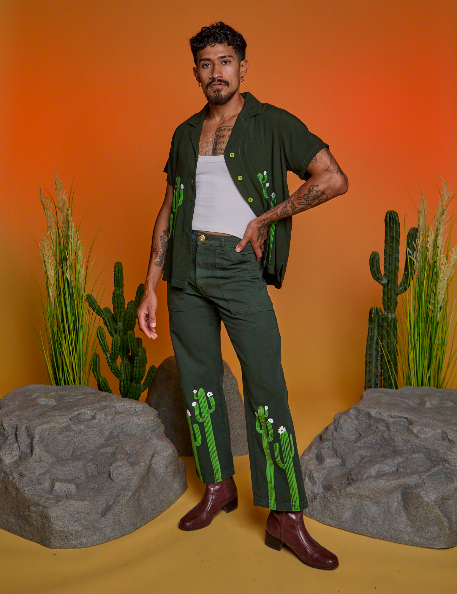 Jesse is 5'8" and wearing XS Paintstamped Work Pants in Cactus paired with matching Pantry Button-Up
