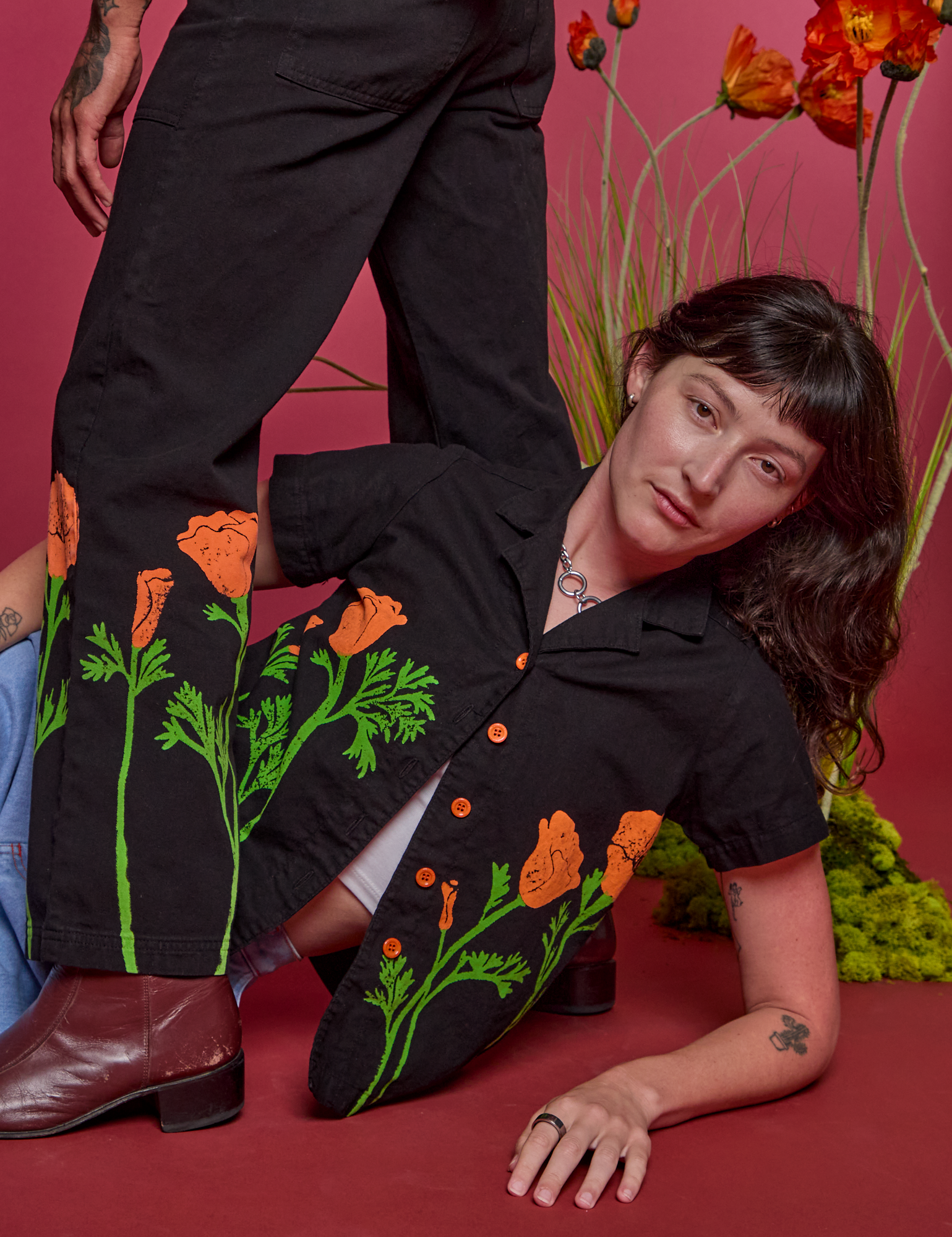 Alex is wearing Paintstamped Pantry Button-Up in Poppy