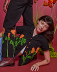 Alex is wearing Paintstamped Pantry Button-Up in Poppy