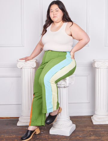 Ashley is 5'7 and wearing 1XL Hand-Painted Stripe Western Pants in Bright Olive paired with a vintage off-white Tank Top