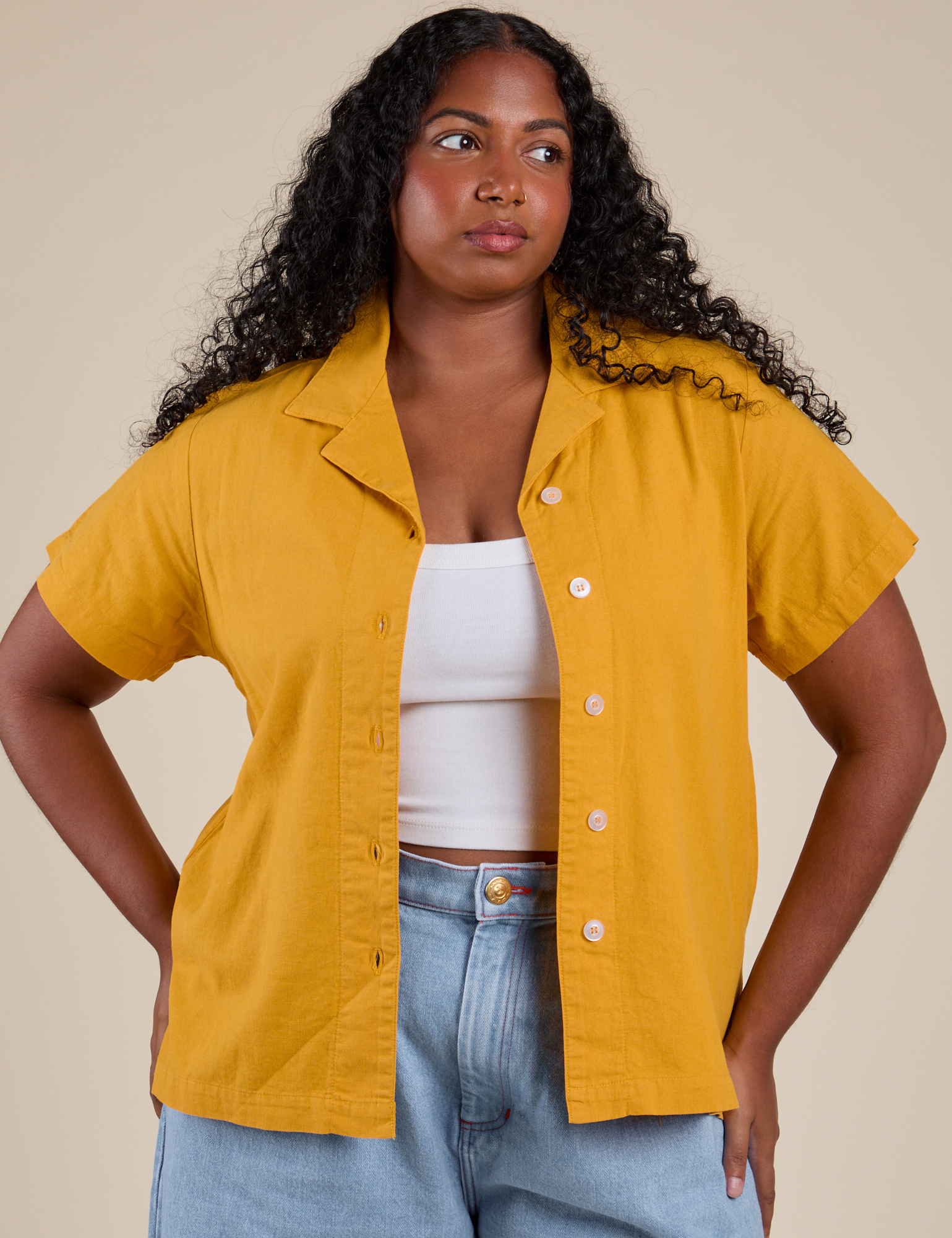 Meghna is 5’8” and wearing M Pantry Button-Up in Mustard Yellow