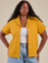Meghna is 5’8” and wearing M Pantry Button-Up in Mustard Yellow