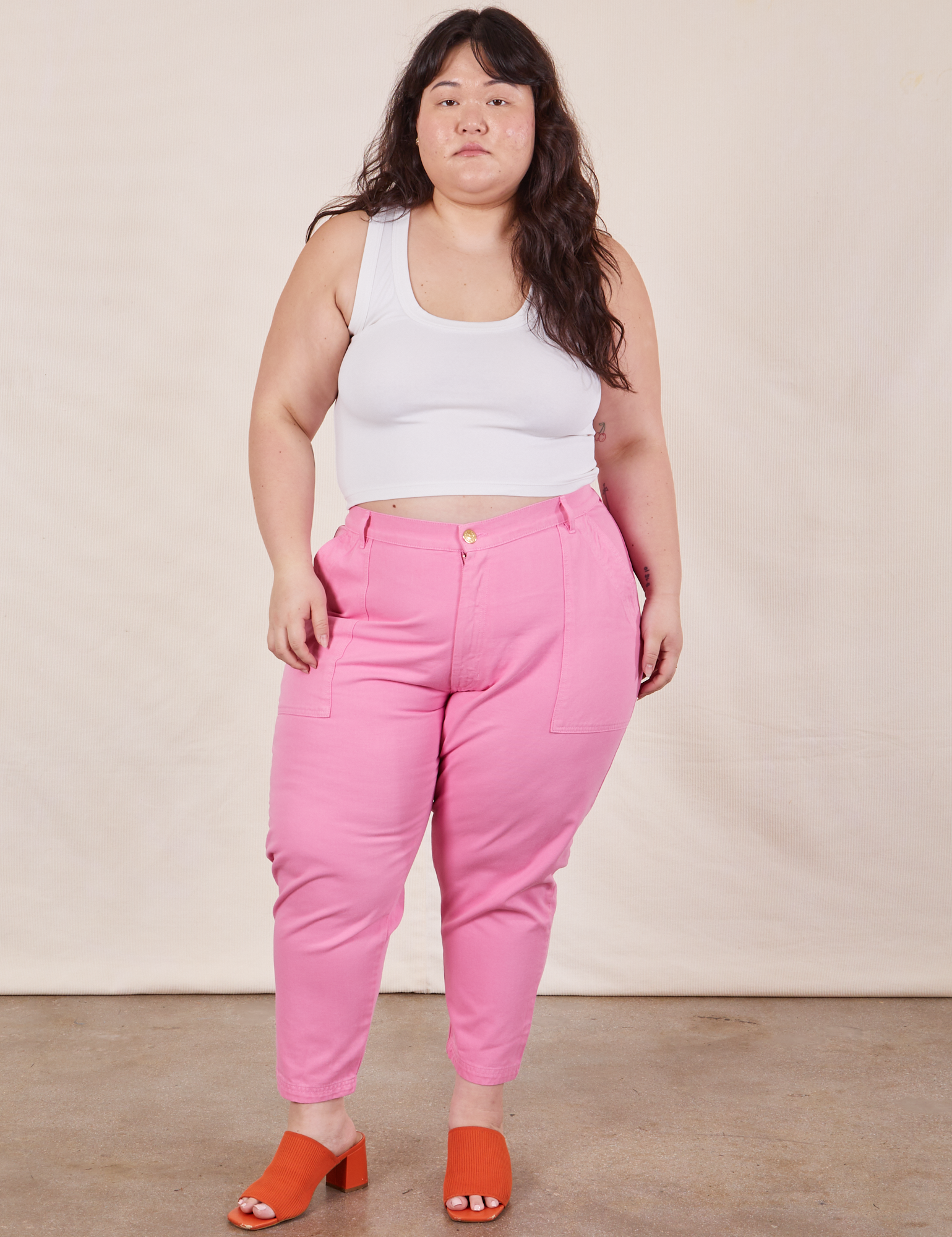 Ashley is 5&#39;7&quot; and wearing 1XL Petite Pencil Pants in Bubblegum Pink paired with vintage off-white Cropped Tank Top