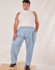 Miguel is 6'0" and wearing 1XL Heavyweight Trousers in Periwinkle paired with vintage off-white Sleeveless Turtleneck