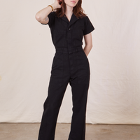 Hana is 5’3” and wearing XXS Petite Short Sleeve Jumpsuit in Basic Black