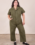 Ari is 5'3" and wearing XL Petite Petite Short Sleeve Jumpsuit in Surplus Green