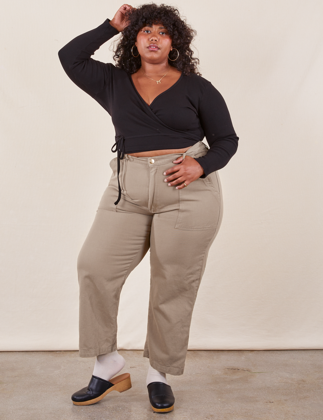 Morgan is 5'5" and wearing Petite 1XL Work Pants in Khaki Grey paired with black Wrap Top