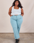 Morgan is 5'5" and wearing 2XL Work Pants in Baby Blue paired with a Cropped Tank in vintage tee off-white