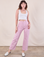 Alex is 5'8" and wearing XXS Work Pants in Lilac Purple paired with a Cropped Tank in Vintage Tee Off-White