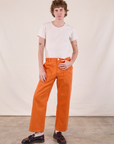 Quinn is 6’4” and wearing M Work Pants in Construction Orange paired with Burly Tee in Vintage Tee Off-White