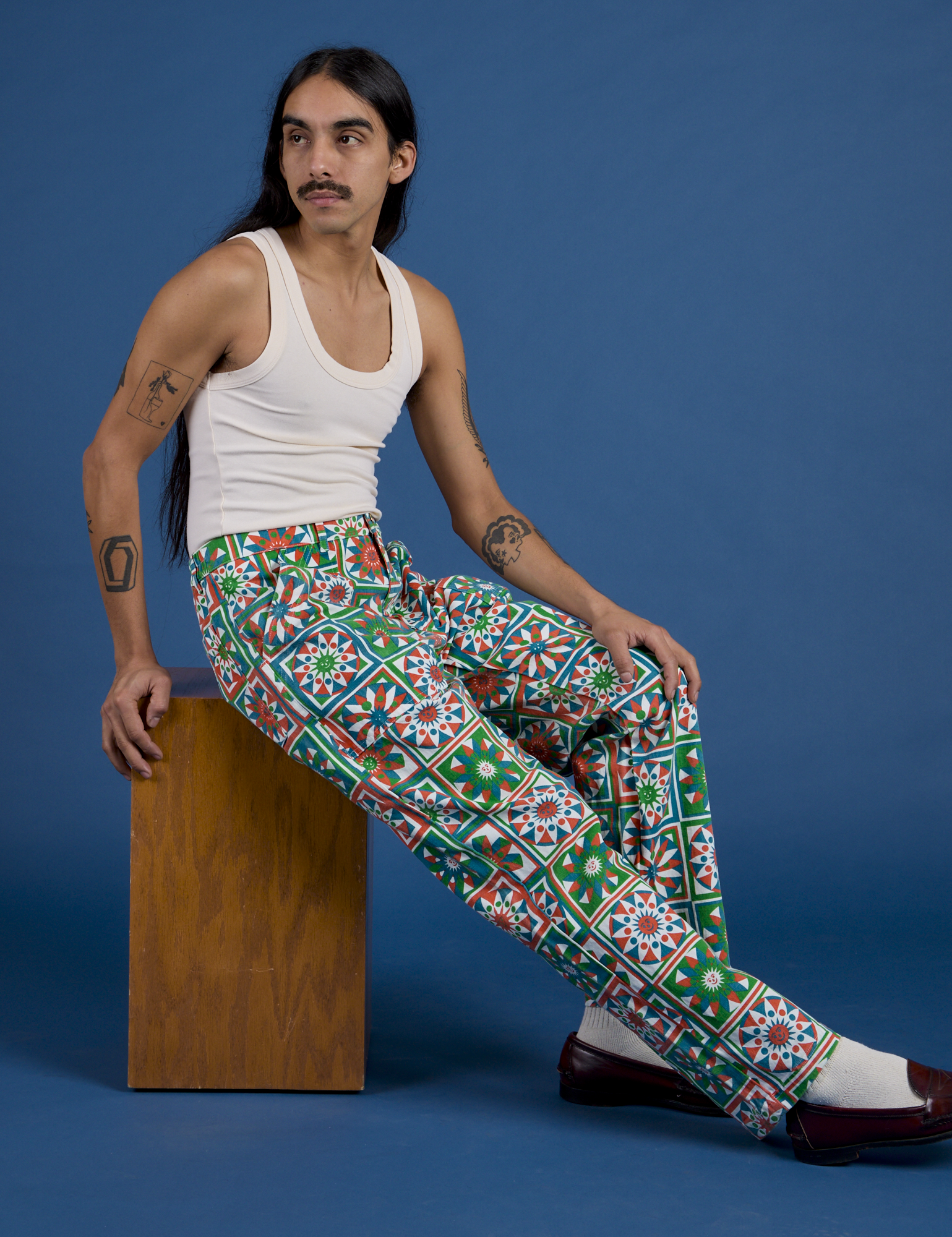 Anthony is wearing Work Pants in Quilt Print paired with a Tank Top in vintage tee off-white