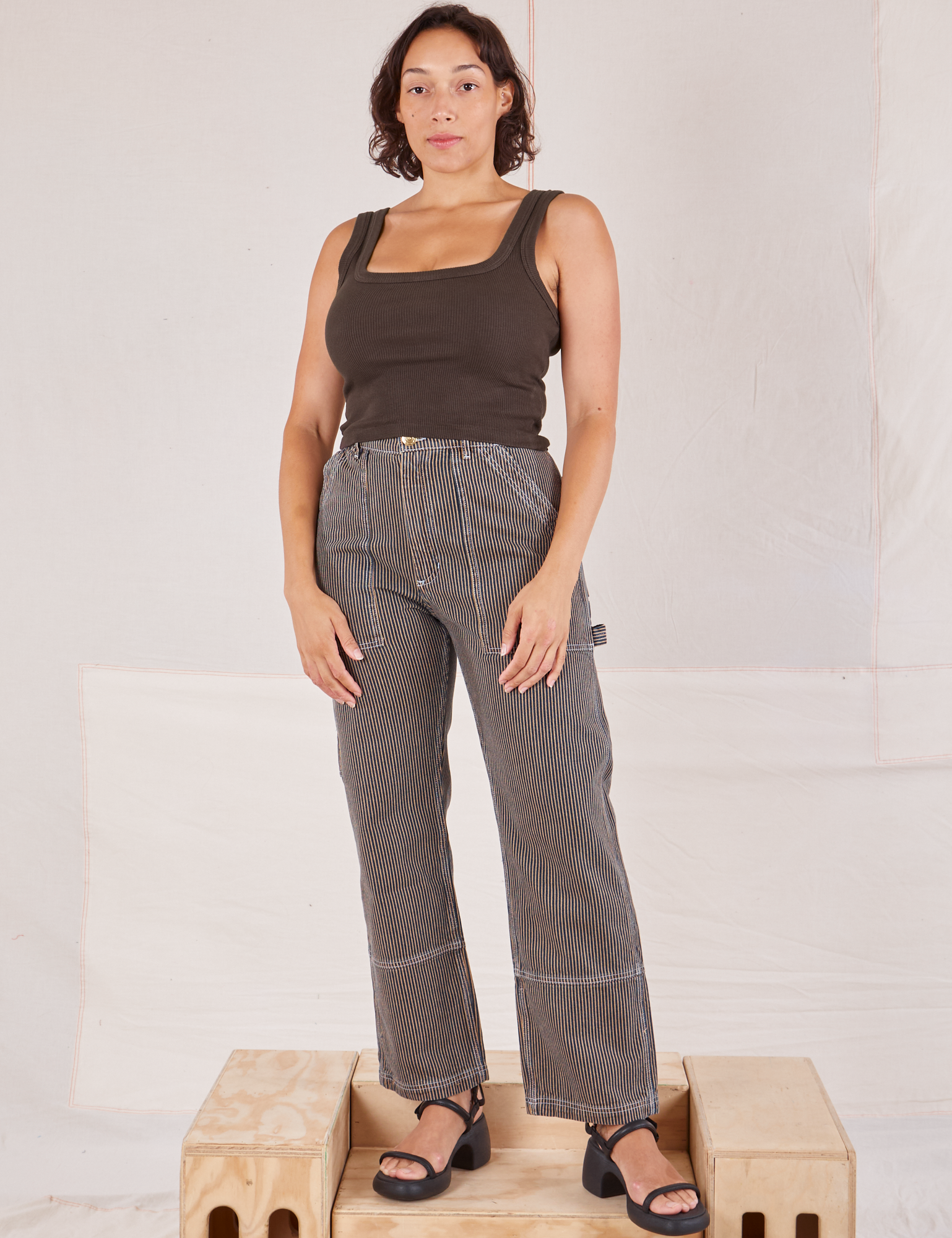 Tiara is 5&#39;4&quot; and wearing S  Railroad Carpenter Jeans in Vintage Tan paired with espresso brown Square Neck Tank