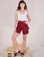 Alex is 5'8" and wearing XXS Railroad Carpenter Shorts in Mustang Red paired with a Cropped Tank in Vintage Tee Off-White