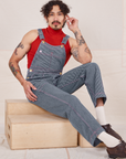 Jesse is 5'8" and wearing XXS Railroad Stripe Denim Original Overalls paired with paprika Sleeveless Turtleneck 