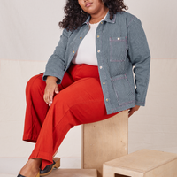 Morgan is 5'5" and wearing 1XL Railroad Stripe Denim Work Jacket paired with paprika Western Pants