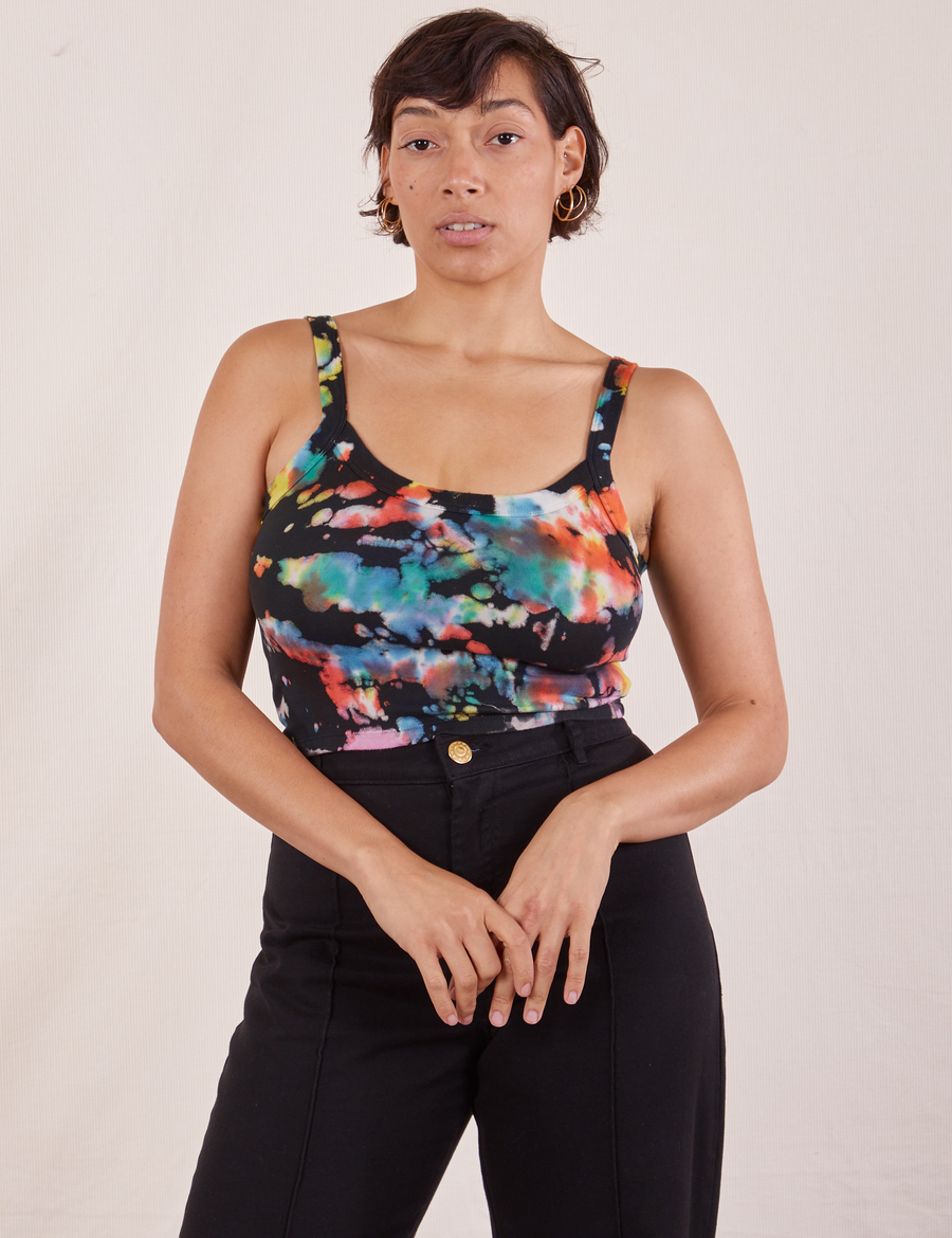 Tiara is 5'4" and wearing XS Cropped Cami in Rainbow Magic Waters paired with black Western Pants