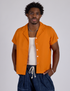 Isaac is 5’10” and wearing M Pantry Button-Up in Creamsicle Orange