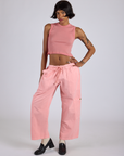 Kira is 5’10” and wearing XS Drop Pocket Cargo Pants in Baby Pink paired with matching Muscle Tee