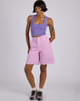 Kira is 5’10” and wearing XS Longline Work Shorts in Lilac Purple paired with a faded grape Cropped Tank