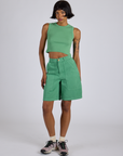 Kira is 5’10” and wearing XS Longline Work Shorts in Seafoam Green paired with matching Muscle Tee
