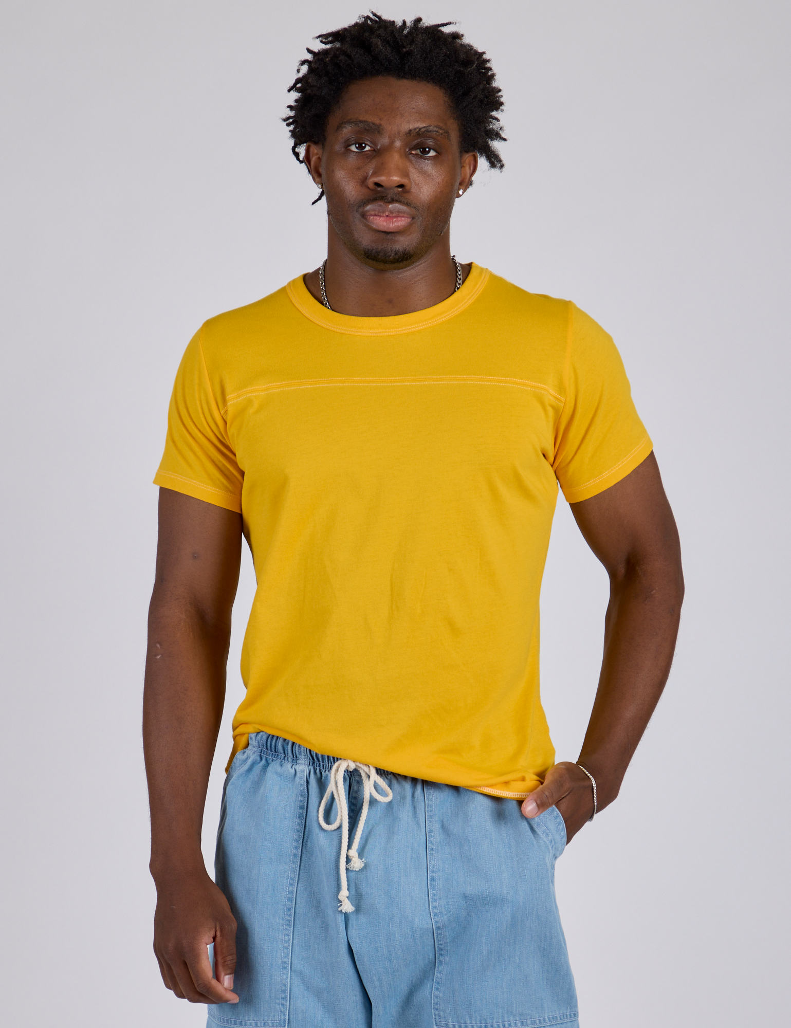 Isaac is 5’10” and wearing M Jr. Varsity Tee in Sunshine Yellow